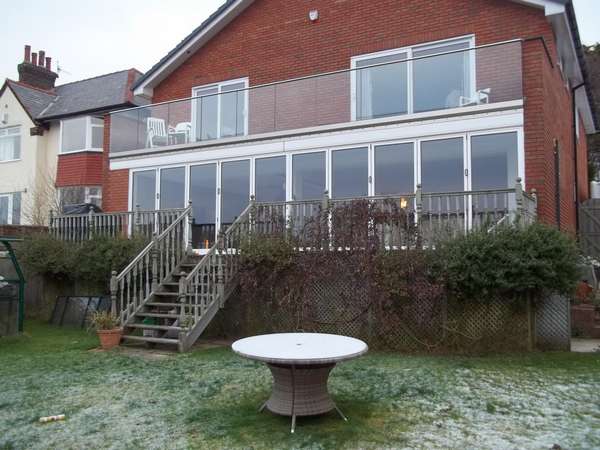 Mr & Mrs H. . CALDY , WIRRAL : Installation of a set of 10m wide slimfold A10 Aluminium Bi Fold doors double glazed . Marine finsh Polyester Powder Coated Std white . CLL Balastrading glazed with heat- soak 15mm toughened Laminated glass